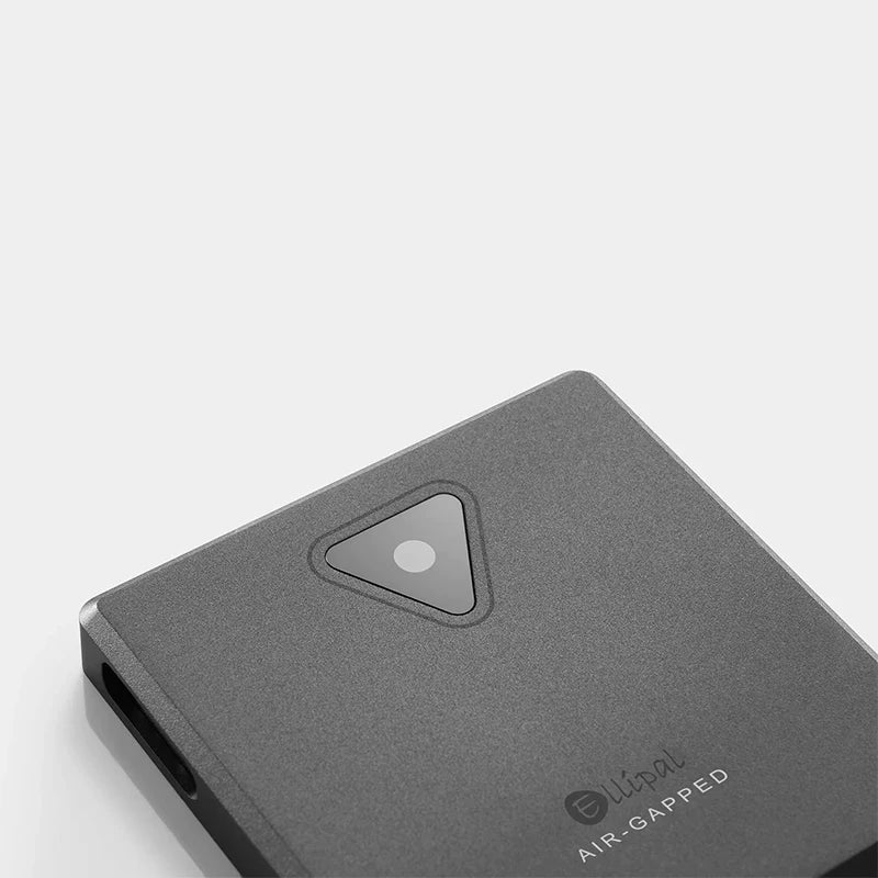 Image of a gray electronic device with a triangular button that has a small circular marking inside, labeled as "ELLIPAL Titan Mini" on its surface. The device, known for its sleek design and high security, is branded under HeadphoneHeat and manufactured in Mainland China.