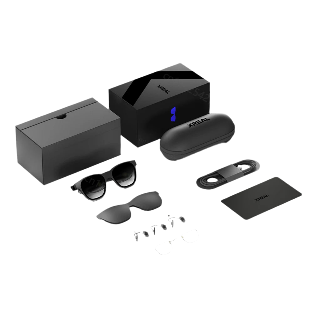 Image showing the contents of a HeadphoneHeat XREAL Air AR Glasses - Nreal Portable 3D HD package. Includes a black box, a black case, a pair of AR glasses, two additional lenses, nose pads, a high-speed connectivity cable, and a rectangular card. All items are neatly arranged on a white background.