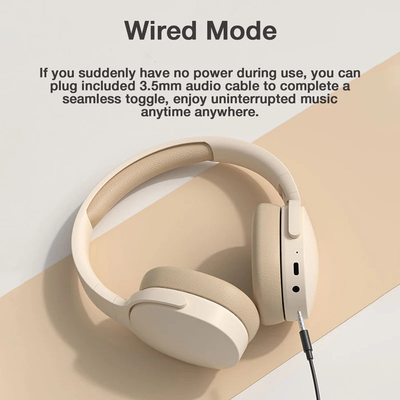 The GENAI P2961 Wireless Headphones by HeadphoneHeat, featuring Bluetooth 5.3 Hi-Res Audio, are displayed in beige with a 3.5mm audio cable attached against a two-tone beige and cream backdrop. The accompanying text emphasizes the benefits of "Wired Mode" for continuous music enjoyment, guaranteeing excellent sound quality even at low battery levels.