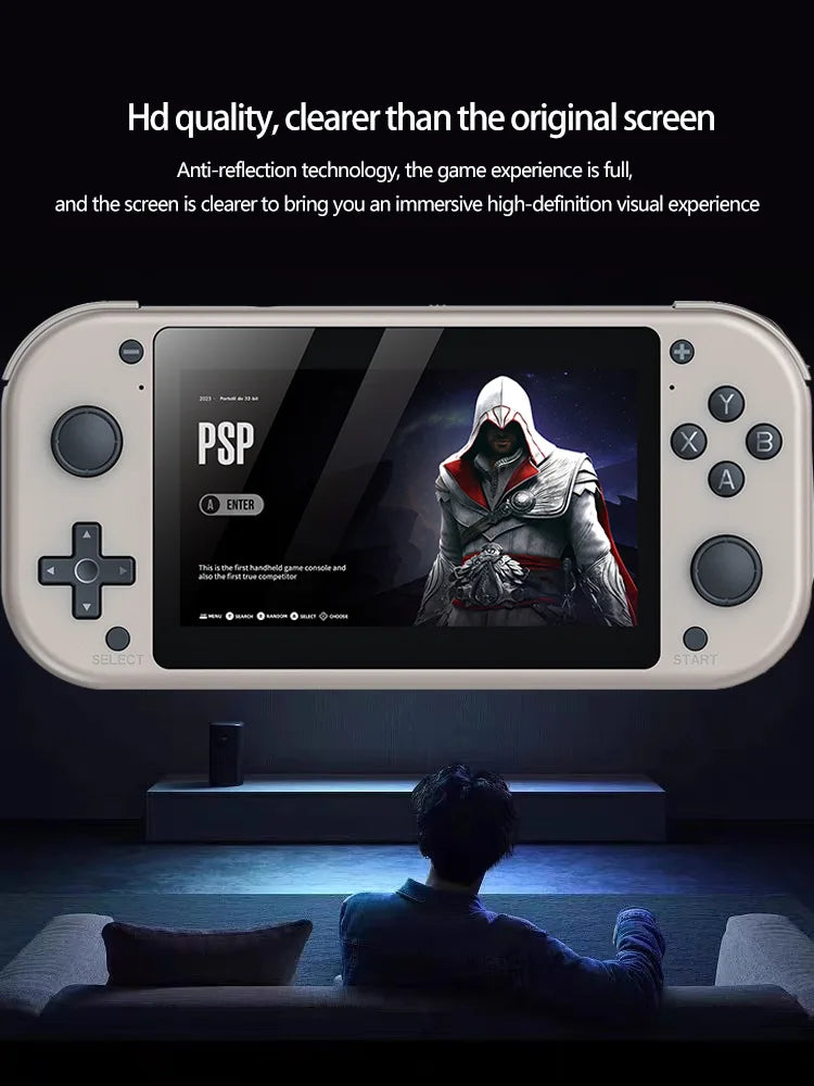 A handheld gaming console, the HeadphoneHeat HRUEDA M17 Handheld Portable Game Console Linux PSP/N64, with an Assassin character displayed on its screen. The console has a white body with various buttons and a directional pad. A person is seated in front of a television screen, playing in a dark room. Text promotes HD quality and anti-reflection technology—perfect for classic game enthusiasts.