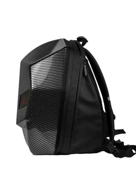 Side view of the LED Hardshell Motorcycle Backpack by HeadphoneHeat, showcasing its fashion-forward design with a sleek black profile and carbon fiber texture on the front panel. It features a top handle, adjustable shoulder straps, and a side zipper for modern convenience.