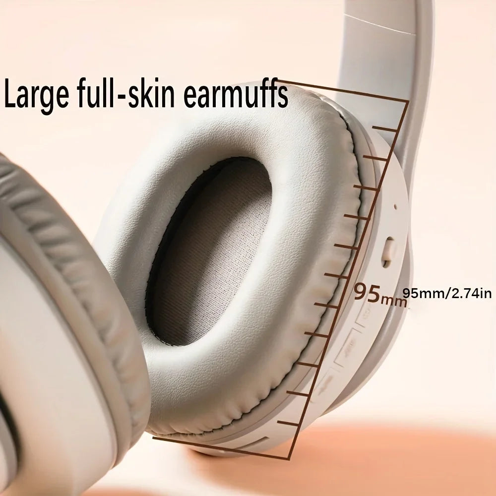 Close-up of the HeadphoneHeat Bluetooth HIFI Wireless Stereo headphones, featuring white full-skin earmuffs with a diameter of 95mm (or 2.74 inches) to provide dynamic sound quality. The text reads "Large full-skin earmuffs." The background is a soft, neutral color.