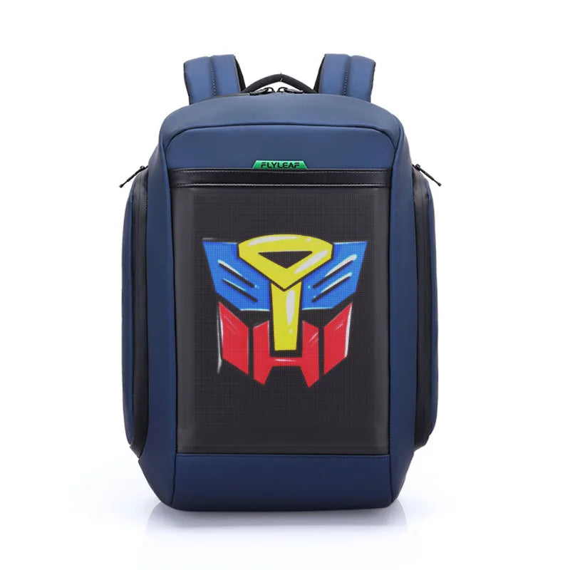 Introducing the Flashback backpack with HD Display from HeadphoneHeat: a blue backpack featuring the Autobot logo from Transformers prominently displayed on the front pocket. Crafted from durable polyester, this backpack boasts multiple interior compartments with zippers visible on the sides and top.