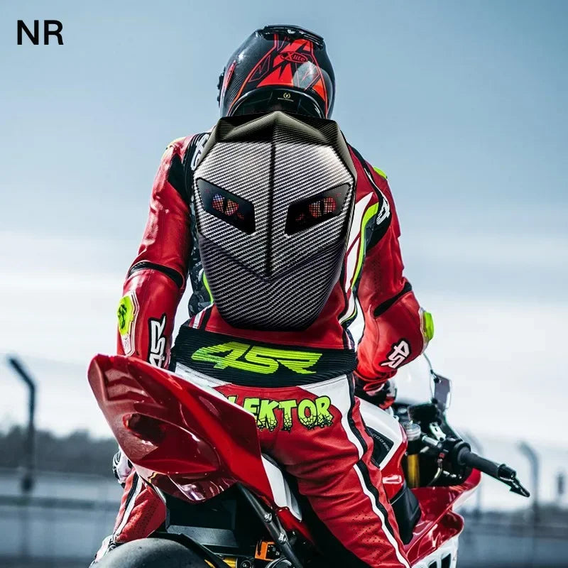 Wearing a cutting-edge design with bright green accents and numbers, a motorcyclist rides a red sportbike on the track. Equipped with the HeadphoneHeat LED Hardshell Motorcycle Backpack, their red and black suit and matching helmet provide a striking contrast against the clear sky.