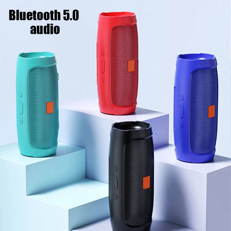 Four HeadphoneHeat Portable Waterproof Subwoofer Bluetooth Speakers in red, blue, black, and teal are stylishly arranged on light blue steps. Featuring a sleek cylindrical design with a mesh grill, these speakers provide versatile functionality for any setting.