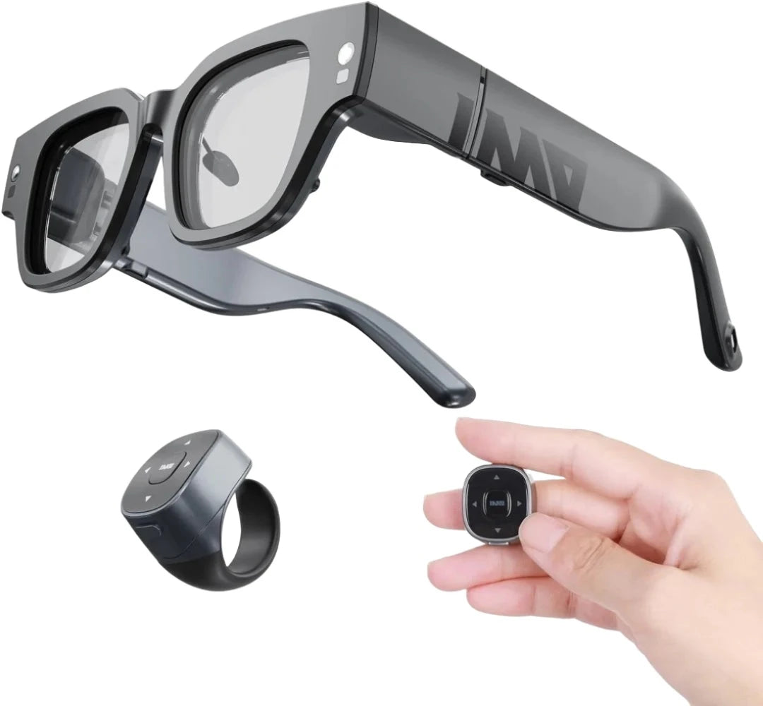 A pair of black smart glasses with a sleek, modern design, paired with a black wearable ring equipped with control buttons, and a small round detachable module being held by a hand. The HeadphoneHeat Inmo Air 2 -Smart AR Ring Control glasses feature advanced technology and have a camera on the side of one frame.