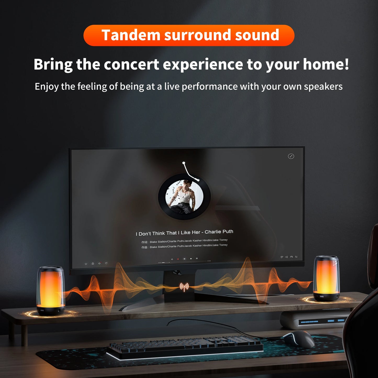 A modern home computer setup showcases a widescreen monitor with a music player interface. Two chic QERE Bluetooth Speakers by HeadphoneHeat emit orange soundwave visuals from the desk. Text above reads: "Experience Tandem Surround Sound with the Exceptional Audio Performance of HeadphoneHeat's QERE Speaker. Bring the concert experience to your home!