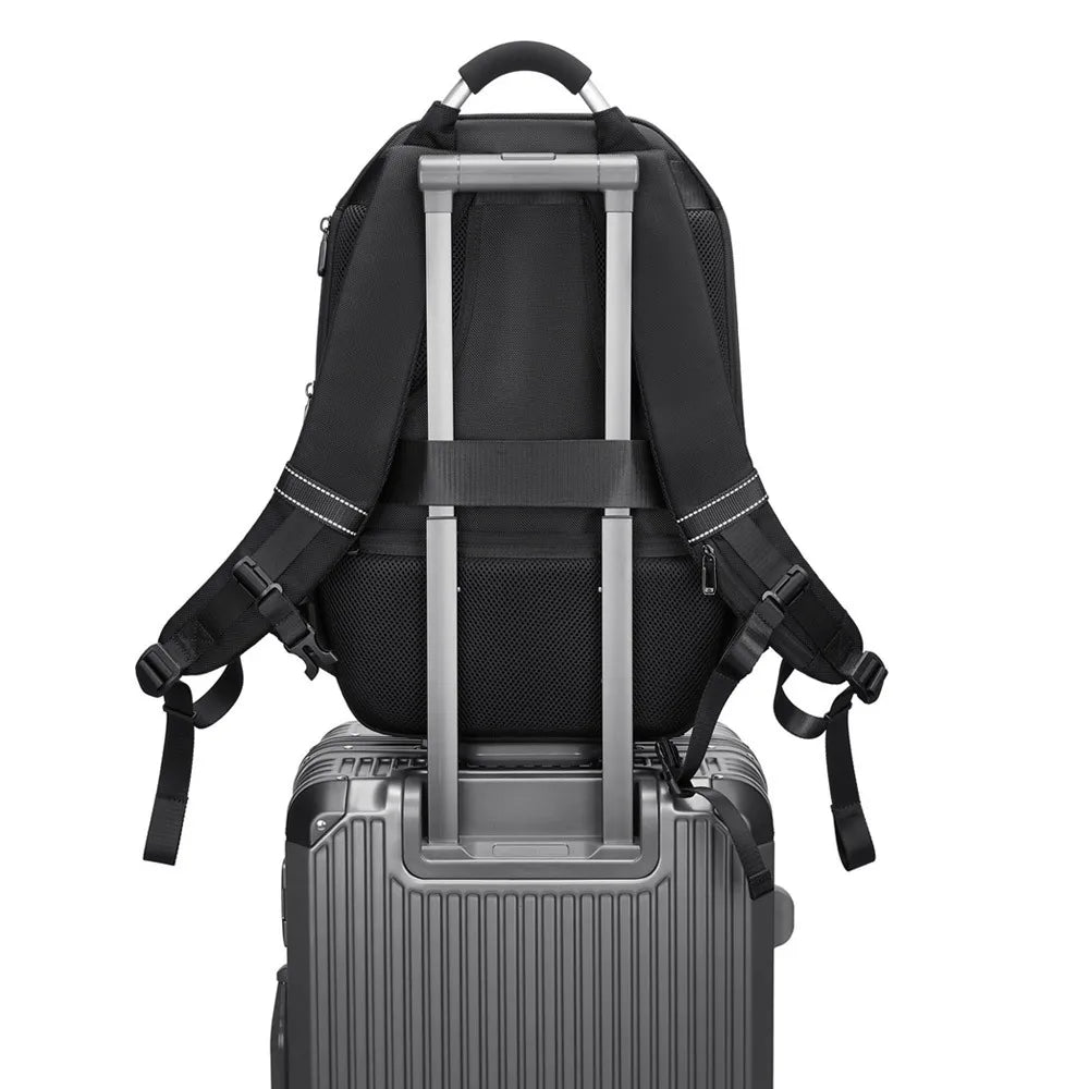 A CFUN LED Multimedia Business Men's Backpack by HeadphoneHeat, featuring padded shoulder straps, attaches to the extended handle of a sleek silver hard-shell suitcase. Constructed from durable PVC, it includes a strap that secures it to the suitcase handle for effortless travel.