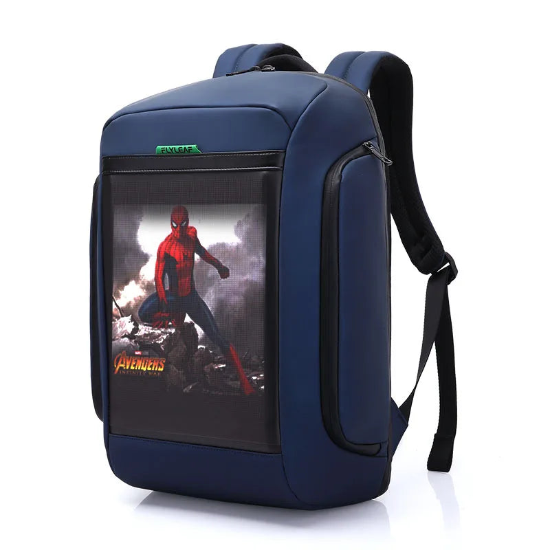 The Flashback backpack with HD Display by HeadphoneHeat is a navy blue backpack made of durable polyester, featuring black straps and a front pocket displaying an image of Spider-Man in costume amidst rubble, with "Avengers" text and logo at the bottom. It also offers multiple interior compartments for easy organization.